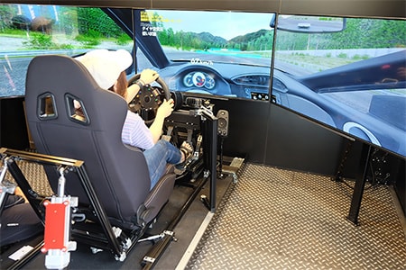A participant using the driving simulator